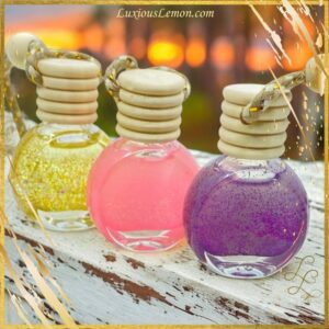 Luxious Lemon Car Air Freshener Trio featuring three glass diffusers in Lemon Pound Cake, Love Spell, and Creme Brulee scents, elegantly packaged in organza bags. Ideal for freshening car interiors, bathrooms, bedrooms, and more with therapeutic-grade essential oils and pet-safe fragrances.