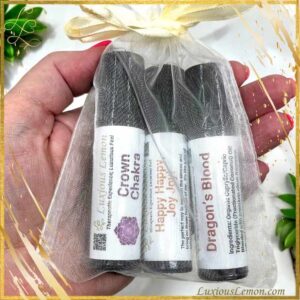 Hand Holding Aroma Roller Bottles in a sheer organza bag